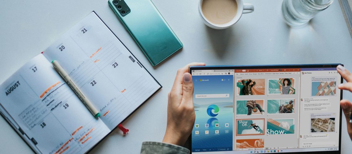 10-Tips-To-Get-The-Most-Out-Of-Your-Microsoft-365-Apps-scaled.jpg person using Windows 11 computer beside white ceramic mug on white table