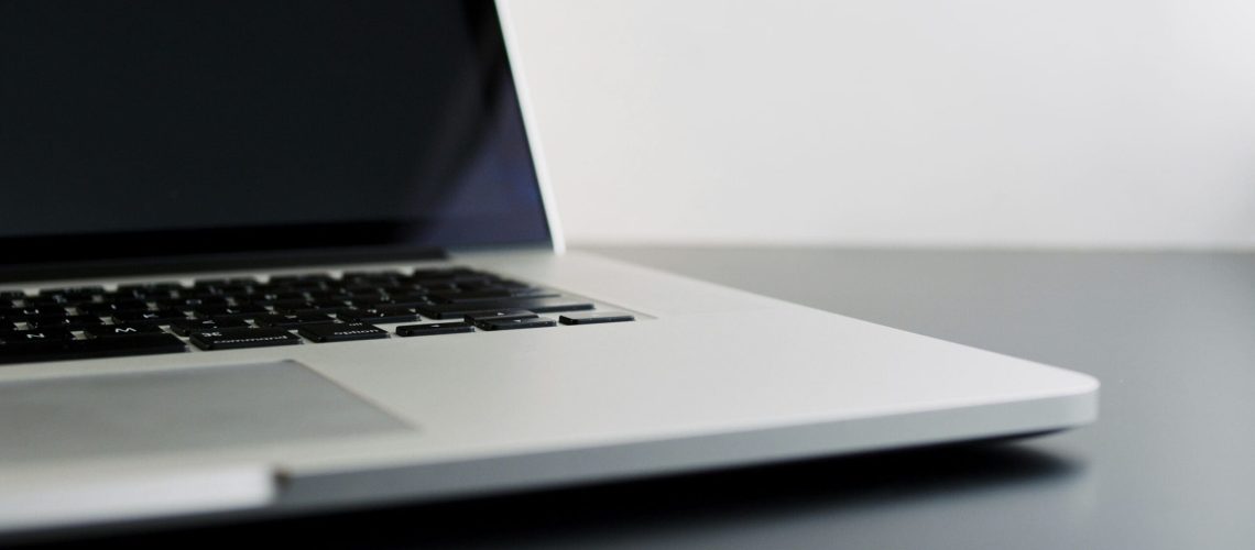 8-Considerations-Before-Buying-Used-Technology-scaled.jpg silver laptop computer on black table