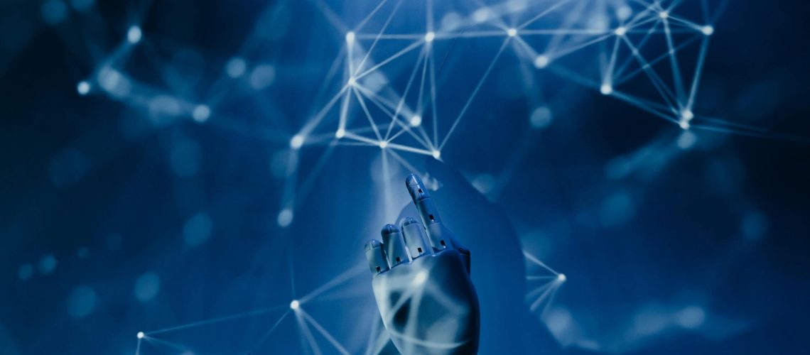 AI-Demystified_-What-to-Know-About-the-Current-Tools-on-the-Market-in-2025-scaled.jpg Free A robotic hand reaching into a digital network on a blue background, symbolizing AI technology. Stock Photo