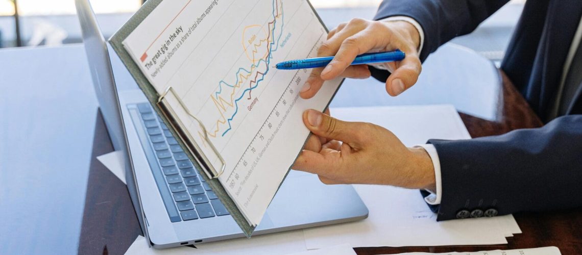 Free Business professionals discussing financial graphs and charts in an office setting. Stock Photo