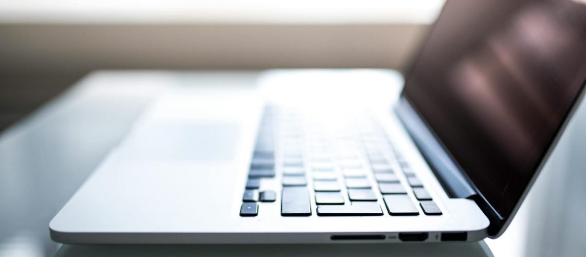 What-Your-Small-Business-MUST-Know-About-Data-Regulations-in-2025-scaled.jpg Free Elegant side view of a laptop on a glossy table with natural lighting indoors. Stock Photo