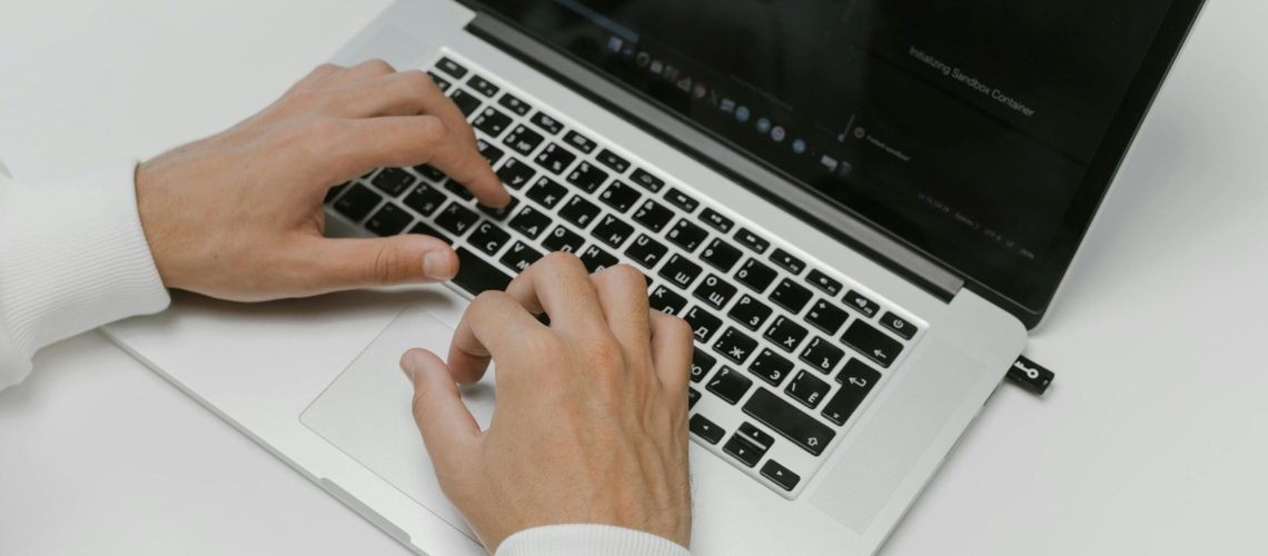 Free Hands on a Laptop Keyboard Stock Photo